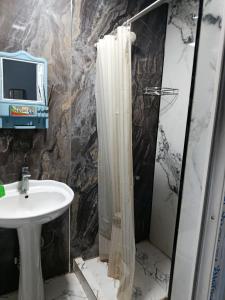 a bathroom with a sink and a shower at Asian Guest House in Bishkek +94 photos