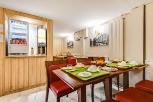 a dining room with a wooden table and chairs at Altona in Paris
