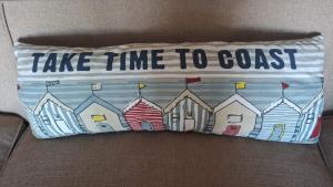 a pillow that says take time to coast at Seven Sardines Beach House in Port Edward