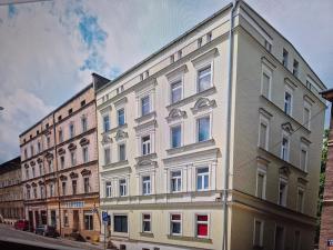 a large white building on a city street at DORMAR II Apartament in Wałbrzych