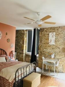 a bedroom with a bed and a stone wall at Les chambres d'Ursule in Tartas +41 photos