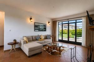 a living room with a couch and a table at The Landing Cottages Family Suite 2 Bedroom in Nanyuki