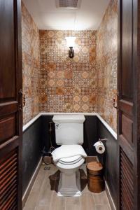a bathroom with a white toilet in a room at Quba by Montraj Pattaya, previously The Quba Hotel Pattaya in Pattaya