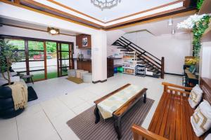 a living room with a bench and a staircase at Silverise Guest House in El Nido