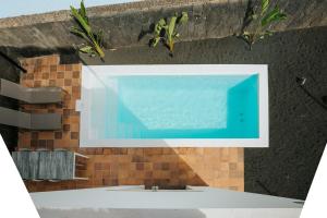 a bathroom with a swimming pool on a wall at Villa Volcano by CasasBlancas in Yaiza
