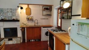 a kitchen with a sink and a stove top oven at La Caldara House in Manziana +22 photos