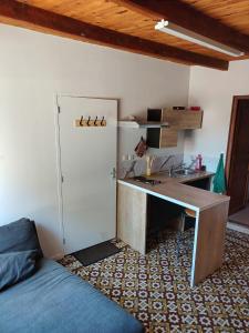 a room with a desk and a bed and a desk and a sink at Studio-Cosy 17-18-19 Centre Bourbourg in Bourbourg