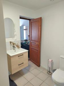 a bathroom with a sink and a toilet and a door at Studio-Cosy 17-18-19 Centre Bourbourg in Bourbourg +31 photos