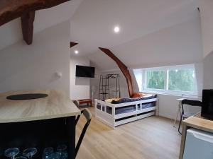 a bedroom with a bed in a room with a window at Studio-Cosy 17-18-19 Centre Bourbourg in Bourbourg