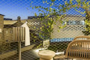 a balcony with a toilet and a fence at MERCURE NIMES CENTRE ARENES in Nîmes