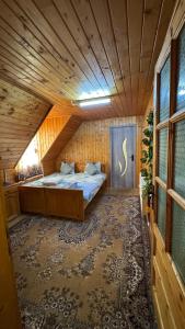 a bedroom with a bed in a wooden room at Cabana Dara in Cumpăna