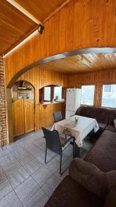 a living room with a table and a couch at Cabana Dara in Cumpăna