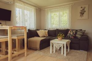 a living room with a couch and a table at Lavender House in Kuressaare