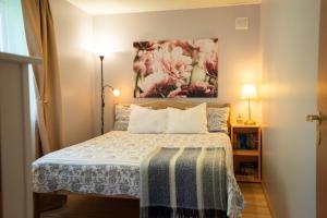 a bedroom with a bed and a painting on the wall at Lavender House in Kuressaare