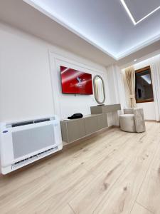 a living room with a television and a living room with a floor at Old Town Inn room 8 in Pogradec