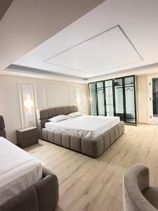 a large bedroom with two beds and a couch at Old Town Inn room 8 in Pogradec