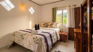 a bedroom with a bed with a cat sitting on it at Le Panpurie Koh Lanta Resort - Near the Beach in Ko Lanta +24 photos