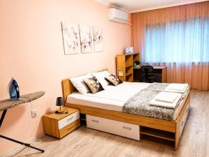a bedroom with a bed and a desk in it at P51 Central - Modern 2 Bedroom Apartment in Stara Zagora