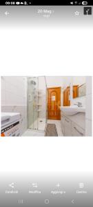 a kitchen with white cabinets and a glass door at Casa Revello in Milan +25 photos