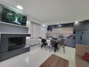 a kitchen and living room with a table and chairs at Cottage in Bakuriani