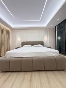 a bedroom with a large bed with a large white bedspread at Old Town Inn room 9 in Pogradec