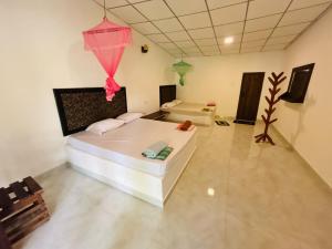 a room with a bed and a kite hanging from the ceiling at Hotel Mandara Udawalawe in Udawalawe