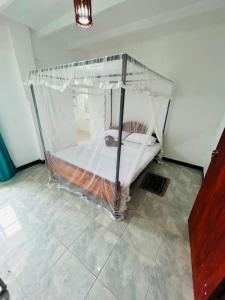 a bedroom with a bunk bed with a net at OLA Villa in Mawella