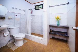 a bathroom with a toilet and a shower and a sink at Silverise Guest House in El Nido +57 photos