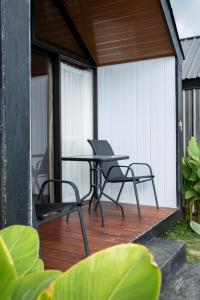 a patio with a table and chairs on a deck at Royal Indah Glamping Kintamani in Kintamani +20 photos
