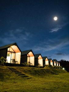 a row of houses on a hill at night at Royal Indah Glamping Kintamani in Kintamani