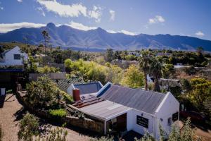 an aerial view of a house with mountains in the background at Serenity Cottage in Swellendam