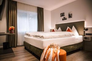 a hotel room with a large bed and a window at weila in Arnsberg