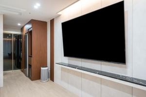 a large flat screen tv on a wall at 제니스 호텔 in Jecheon