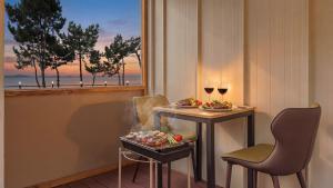 a room with a table with two chairs and wine glasses at Mu-an Prejong Dokchae Pension in Muan