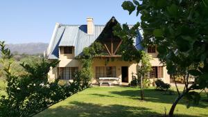 an exterior view of a house with a yard at Tuckaway in Somerset West