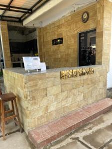 a restaurant with a sign on a brick wall at Tri Putri Kuta Homestay in Kuta Lombok +74 photos