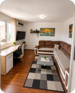 a living room with a couch and a desk at Beautiful duplex apartment with view in Kaštela