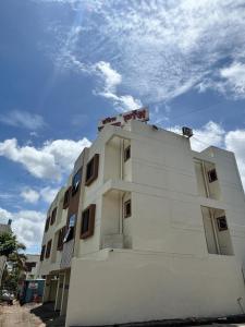 a white building with a sky in the background at Rajratna lodge in Lohogaon