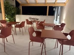 a group of tables and chairs in a room at Gegè Relais in San Corrado di Fuori