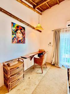a desk in a room with a painting on the wall at The Kokomo Siargao in General Luna