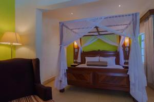 a bedroom with a canopy bed in a room at Toquee Hotel Bookings - Nairobi in Nairobi +12 photos