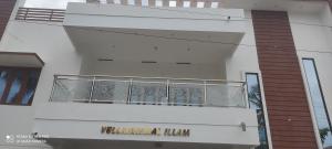 a building with a balcony on the side of it at Velli apartment in Tirunelveli