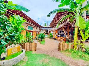a resort with a bunch of buildings and trees at The Kokomo Siargao in General Luna
