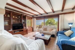 a living room with two couches and a tv at Can Xilla by Sealand Villas in Alcudia