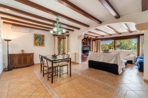 a living room with a table and a couch at Can Xilla by Sealand Villas in Alcudia +33 photos