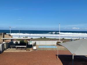a view of the beach with a pool and the ocean at Waveside Guesthouse in Durban