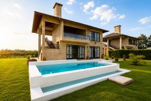 a house with a swimming pool in the yard at The Landing Cottages Family Suite 2 Bedroom in Nanyuki