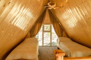 two chairs in a room with a ceiling fan at A-frame Sky in Karakol