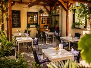 a restaurant with tables and chairs in a room at Hotel Merkur - Czech Leading Hotels in Prague
