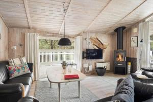 a living room with a couch and a table at 0011-Romo-Trinnesvej-9 in Høm